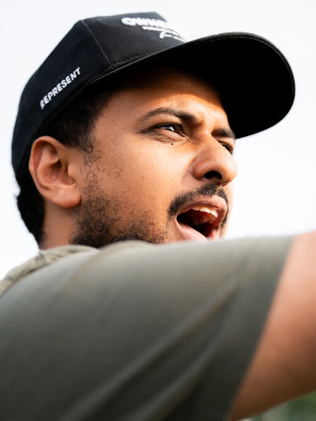 A supporter in a cap, shouting from the sideline